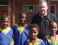 Vega Instruments MD, John Groom with some of the choir members.